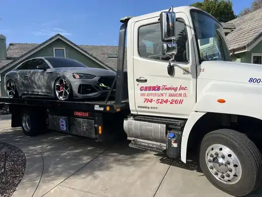 Geer's Towing flatbed transporting an Audi RS 5 sport sedan